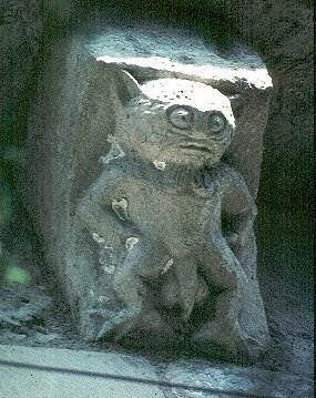 Exterior stone corbel on the church of Saint-Pierre-d'Excideuil (Vienne), France.